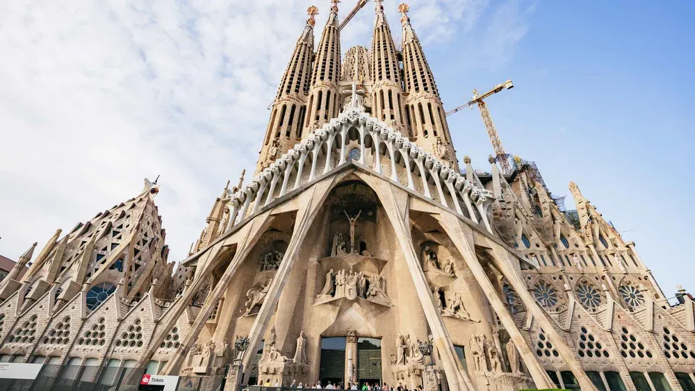Guide leading a small group past the carved Nativity facade on a la sagrada familia tour in Barcelona